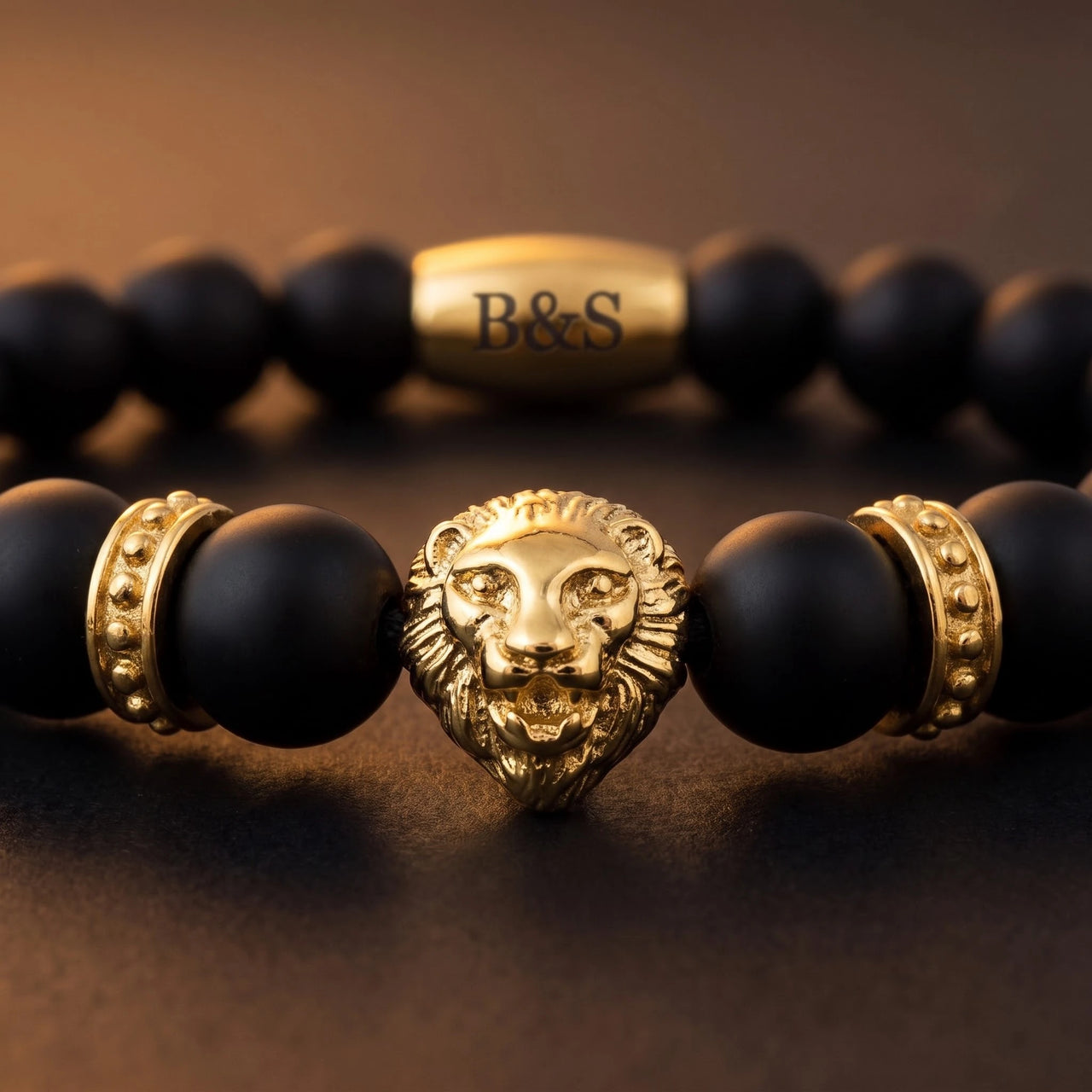 Gold Lion & Black Stones Bracelet – macro detail of the lion head | Brother & Sisters | SKU: 20712286-gold-XS-14-15, 20712286-gold-S-16-17, 20712286-gold-M-18-19, 20712286-gold-L-20-21, 20712286-gold-XL-22-23
