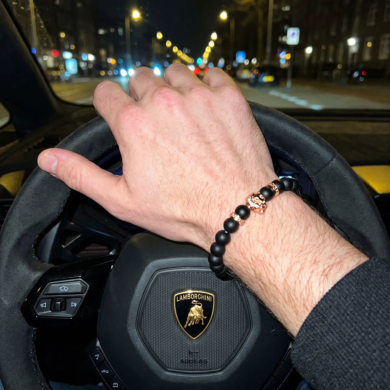 Rose Gold Lion & Black Stones Bracelet – worn at the steering wheel of a luxury car | Brother & Sisters | SKU: 20712286-rose-gold-XS-14-15, 20712286-rose-gold-S-16-17, 20712286-rose-gold-M-18-19, 20712286-rose-gold-L-20-21, 20712286-rose-gold-XL-22-23