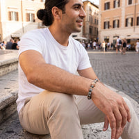 Thumbnail for Rose Gold Lion & Grey Stones Bracelet – worn by a man sitting | Brother & Sisters | SKU: 20866222-rose-gold-XS-14-15, 20866222-rose-gold-S-16-17, 20866222-rose-gold-M-18-19, 20866222-rose-gold-L-20-21, 20866222-rose-gold-XL-22-23