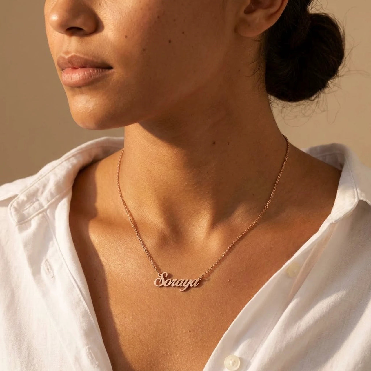 Minimalist Name Necklace in rose gold worn in three-quarter profile, the name Soraya | SKU: minimalistnn-rosegold