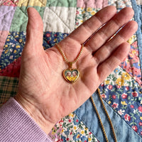 Thumbnail for The gold heart photo pendant in an open palm over a quilt, showing its real small size | SKU: TPH-CHTN-GOLD-SMALL