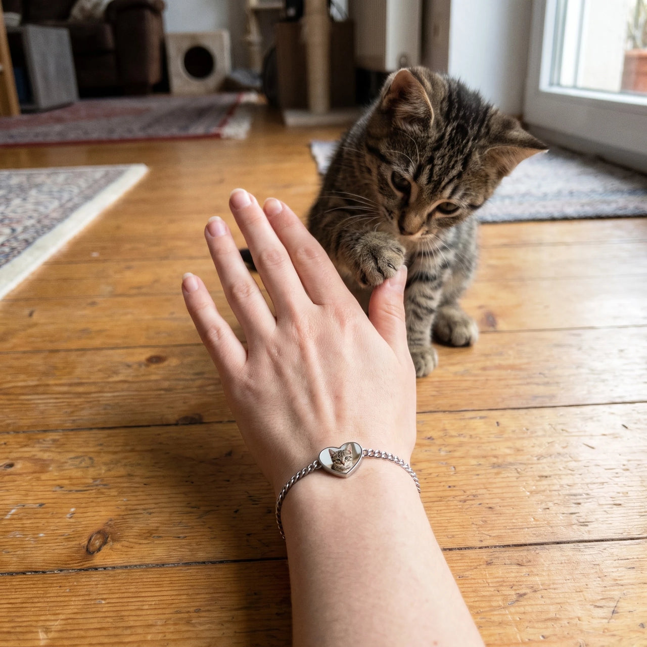 Customer photo: the silver heart bracelet with her kitten's photo, her kitten in the background | SKU: TPH-HRTB-SILVER