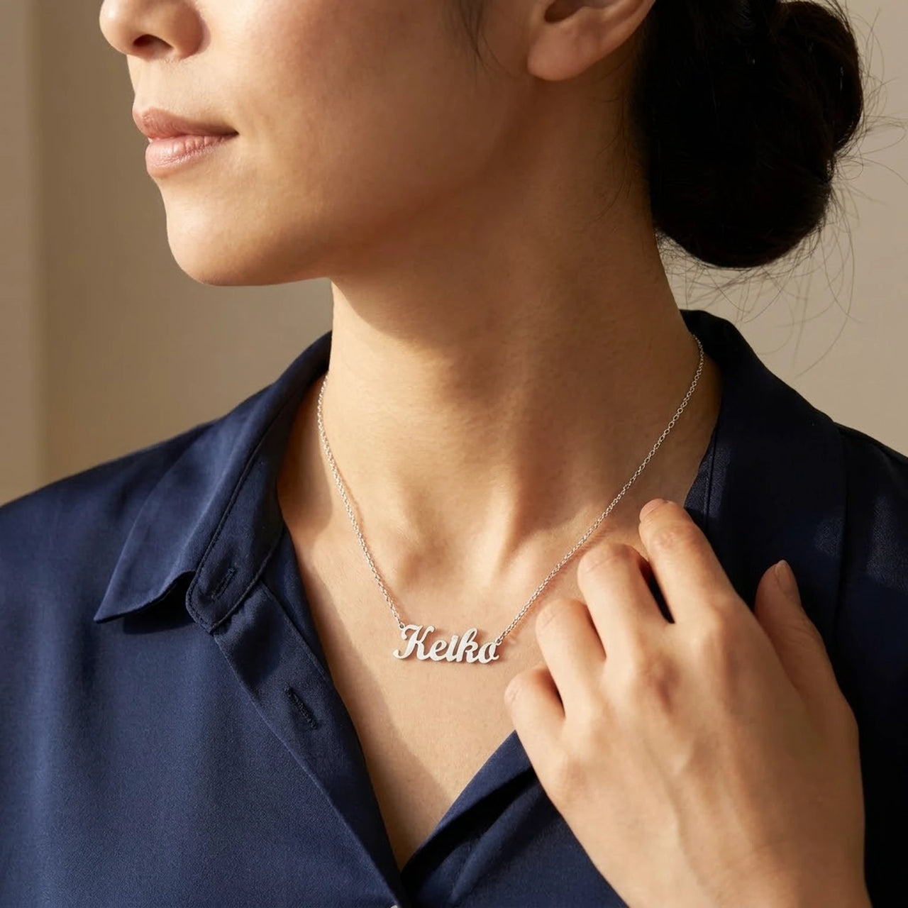 Minimalist Name Necklace in silver worn in three-quarter profile, the name Keiko | SKU: minimalistnn-silver